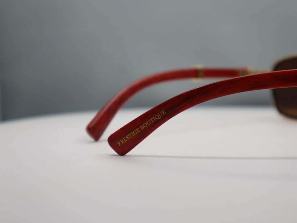 Close-up of Prestige Boutique women's rhinestone sunglasses showcasing elegant red temples.