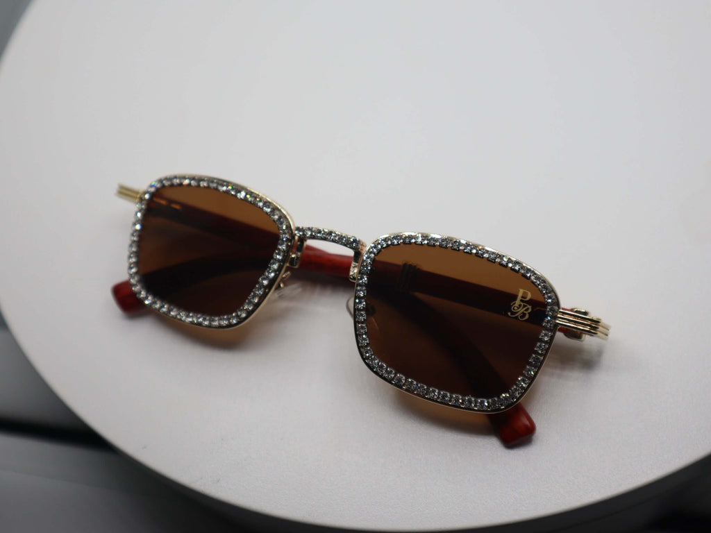 Rhinestone embellished women's sunglasses with brown lenses and gold frames, perfect for stylish sun protection.