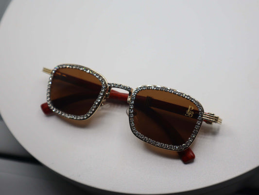 Rhinestone embellished women's sunglasses with brown lenses and gold frames, perfect for stylish sun protection.