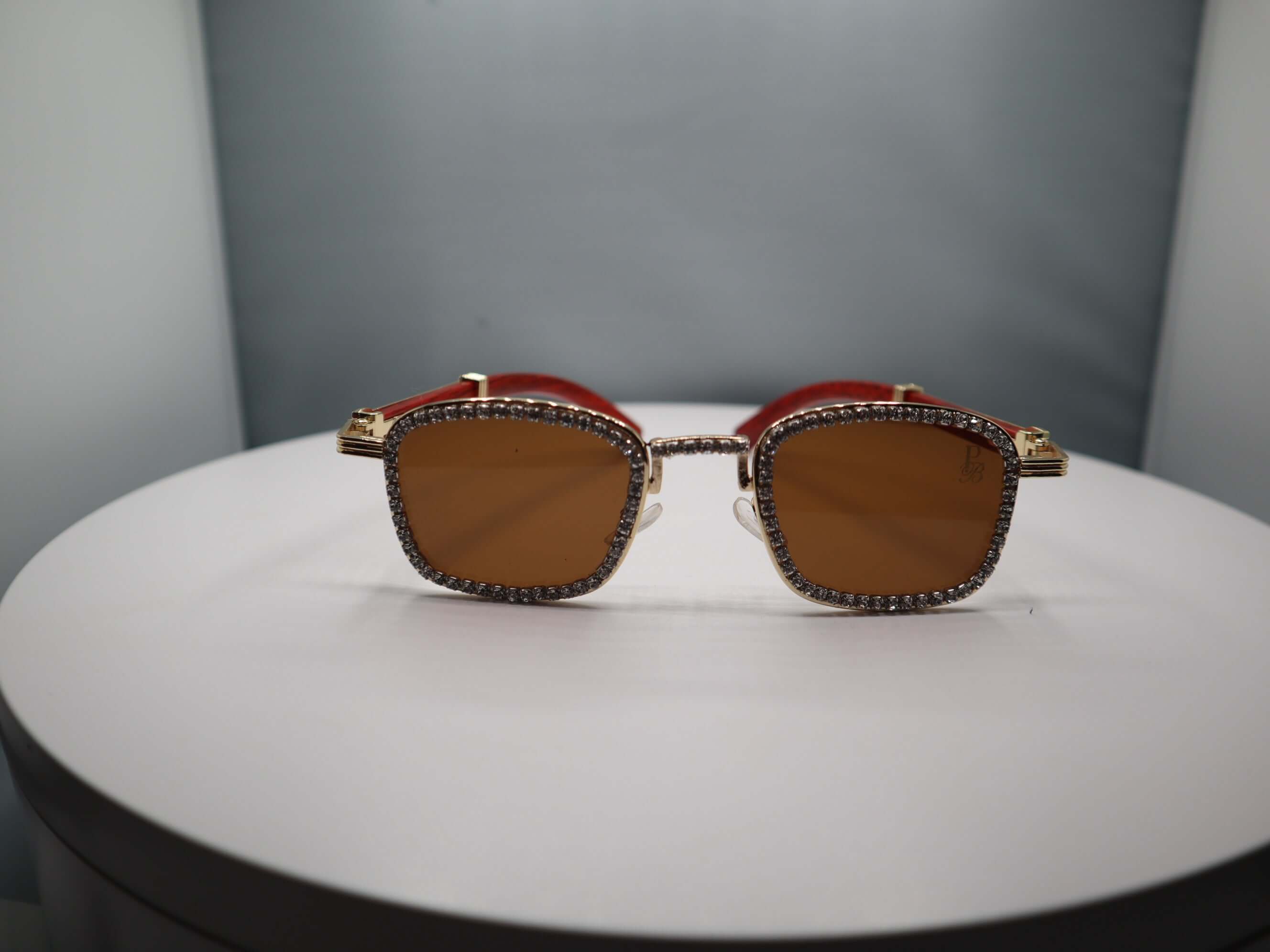 Total Gem women's sunglasses with rhinestone accents on a stylish display, combining luxury and UV protection.